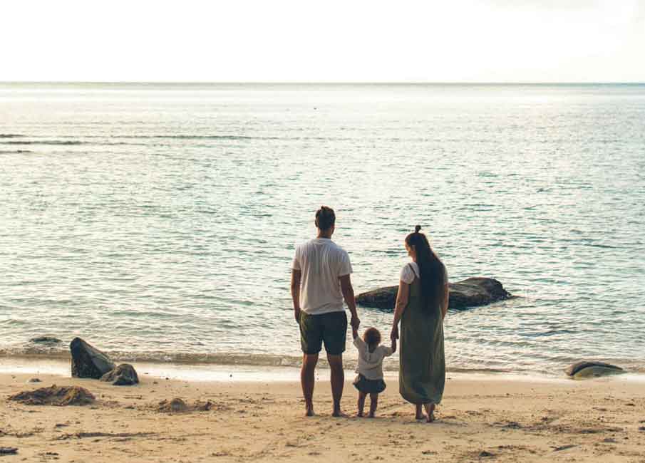 A family holding each other’s hands.