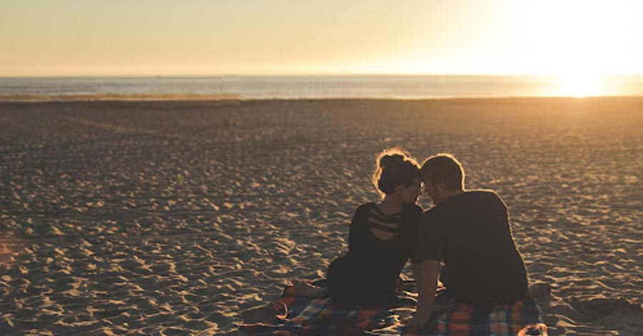 A Couple having a picnic at the beach.